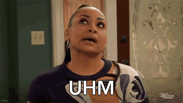 a woman with a shaved head says uhm
