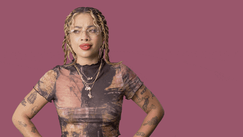 a woman stands with her hands on her hips in front of a purple background that says no