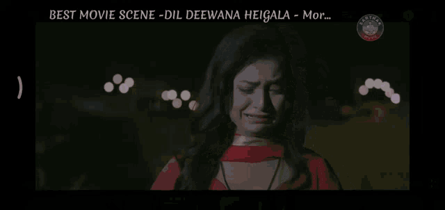 a woman in a red dress is crying in front of a sign that says ' bharat tv ' on it