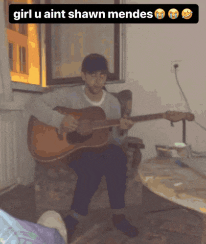 a man playing a guitar with a caption that says girl u aint shawn mendes