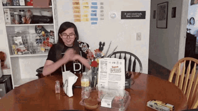 a person sitting at a table with a sign that says if you could talk they wouldn 't