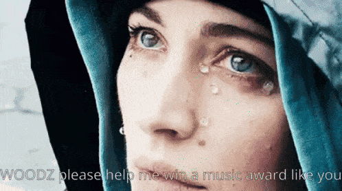 a close up of a woman with tears on her face