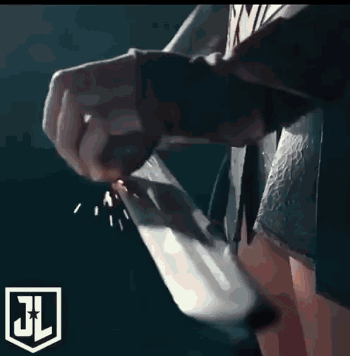 a close up of a person smoking a cigarette with a jl logo in the background .