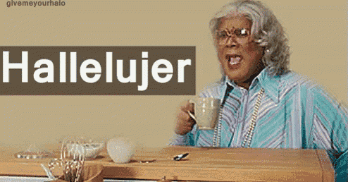a woman sitting at a table with a cup of coffee and a sign that says hallelujer
