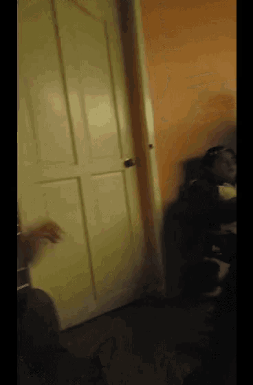 a blurry picture of a person standing in front of a white door