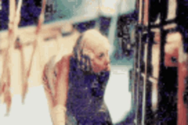 a blurry picture of a person standing in front of a fence .