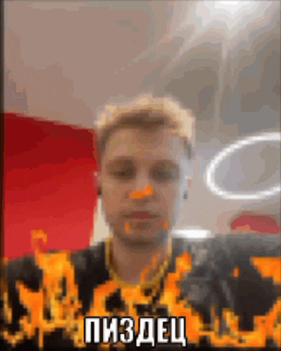 a blurry picture of a man with flames on his shirt and a foreign language written on the bottom