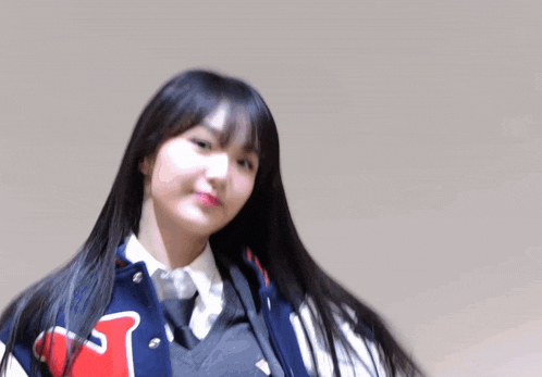 a girl in a varsity jacket with the letter t on it