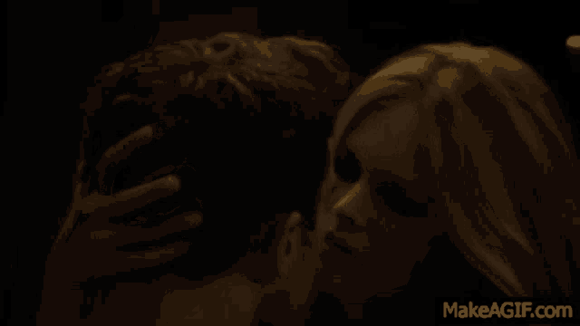 a woman laying on a man 's back with makeagif.com written below her