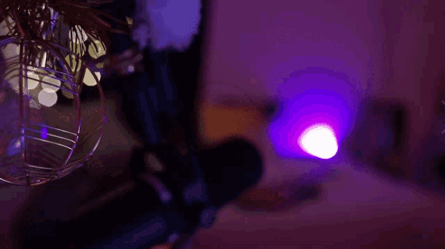 a purple light is hanging from the ceiling in a room