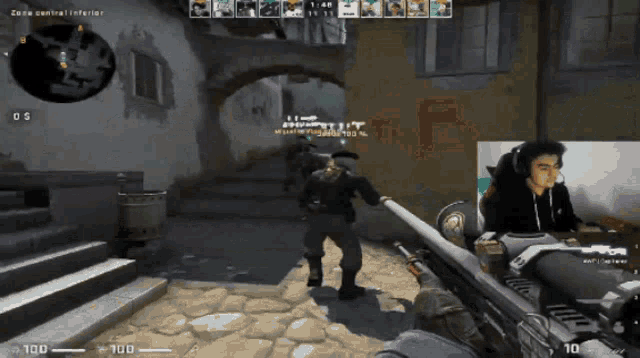 a man is playing a video game with the number 100 on the screen