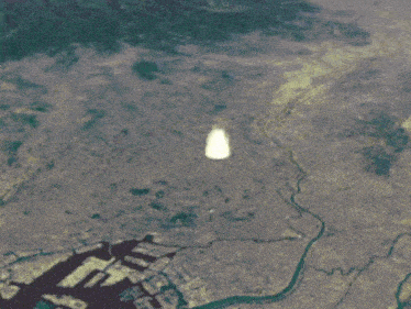 an aerial view of a large explosion in the middle of a field