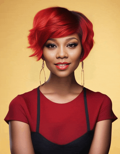 a woman with red hair wearing hoop earrings and a red top