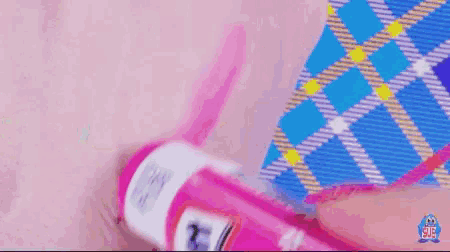 a close up of a person holding a pink pencil with a sticker on it that says ' a ' on it
