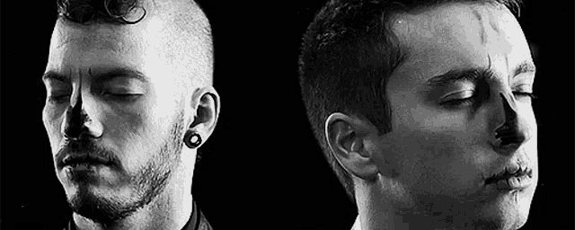 two men are standing next to each other with their eyes closed and one has a scar on his face .