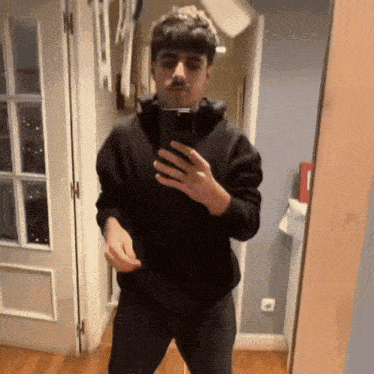 a man is taking a selfie in front of a mirror