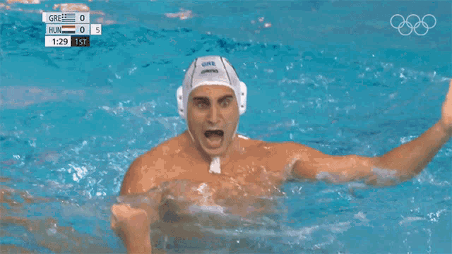 a man in a swimming pool celebrates a goal against hungary