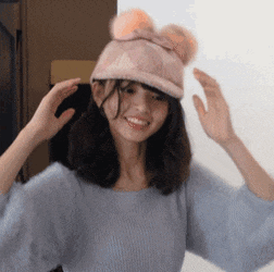 a woman wearing a pink hat with ears on it