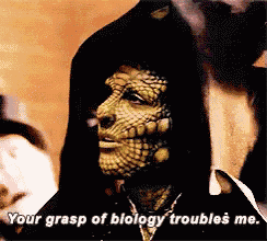 a man with a lizard face is talking about biology