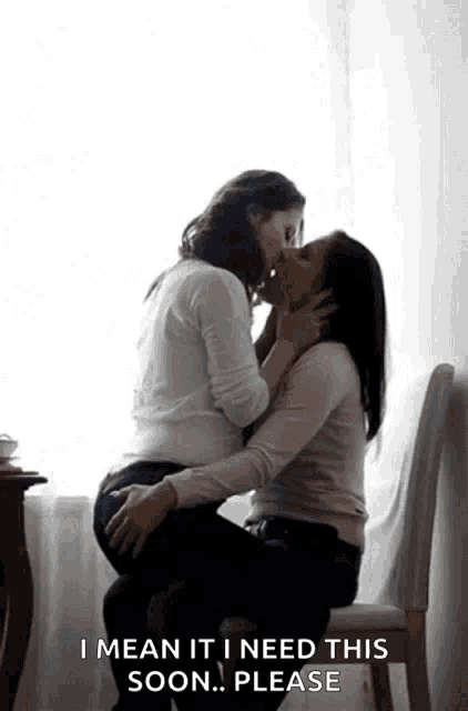two women are kissing in front of a window with the words i mean it i need this soon please