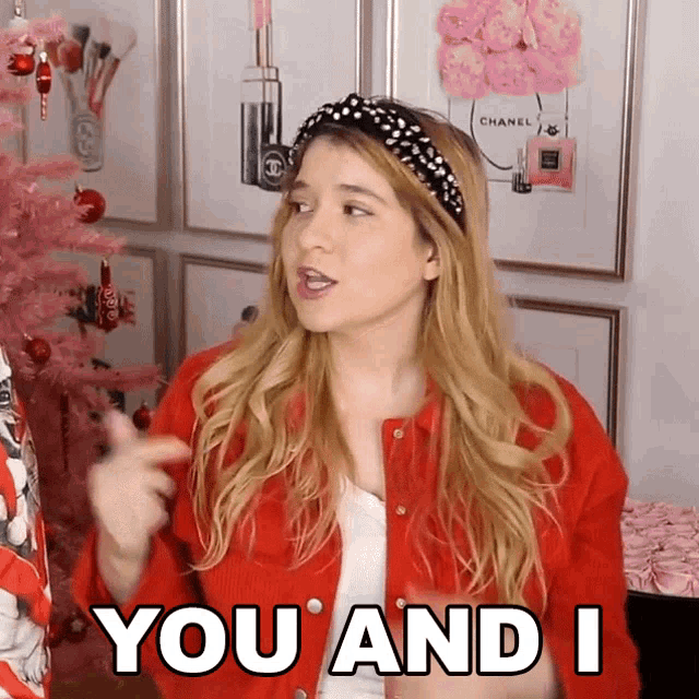 a woman in a red jacket and headband says " you and i "