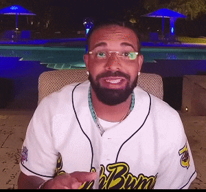 a man with a beard and glasses wears a jersey that says ' bruins ' on the front