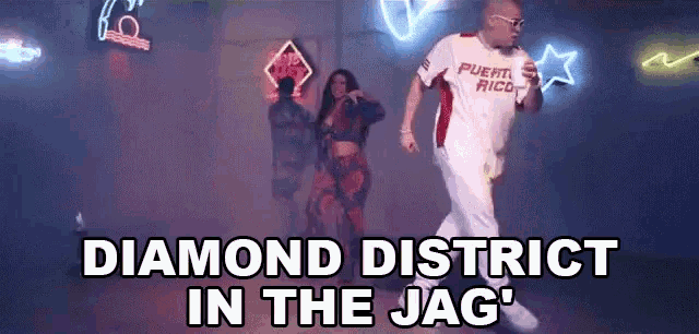 a man and a woman are dancing in a club with the words diamond district in the jag written above them .