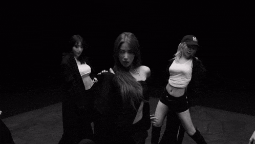 a group of young women are dancing in a black and white photo
