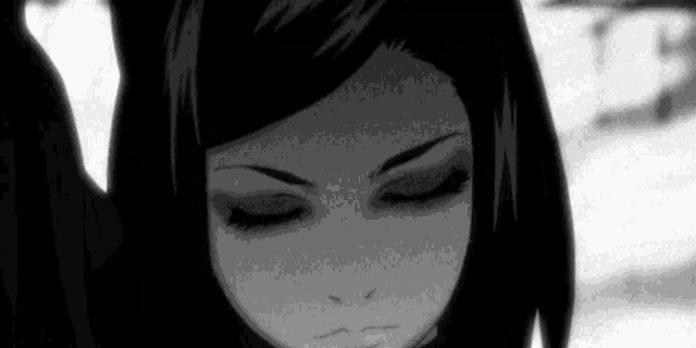 a black and white photo of a woman with her eyes closed .