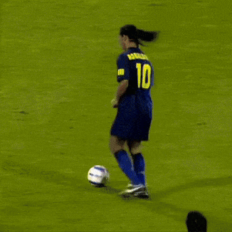 a soccer player in a blue uniform kicks a ball