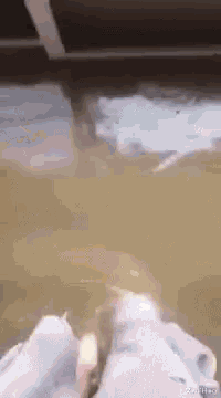a person 's feet are sticking out of a flooded room .