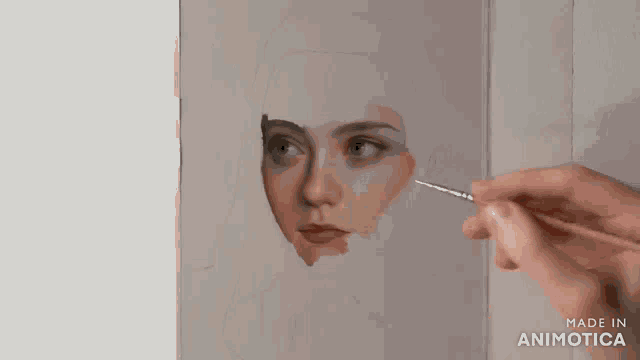 a person is painting a woman 's face with a brush and the words made in animotica are on the bottom
