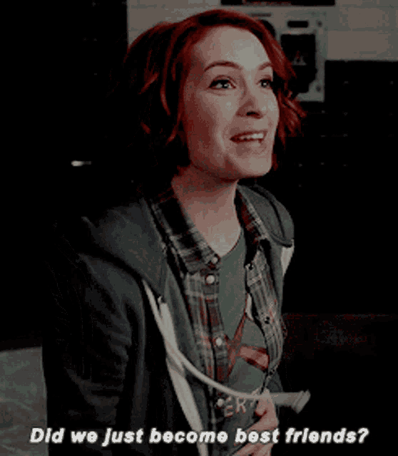 a woman wearing a green shirt that says " did we just become best friends " is smiling