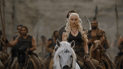 a woman is riding a white horse in a crowd