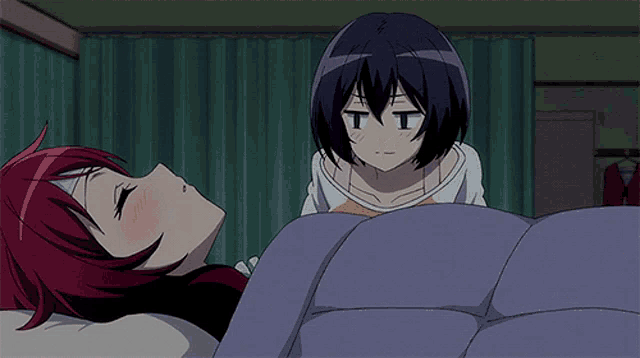 a girl with red hair is laying in a bed with another girl