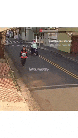 a person riding a motorcycle down a street with the name thiaguinhosep written on the side
