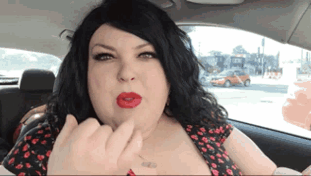 a woman with red lipstick and a tattoo on her chest