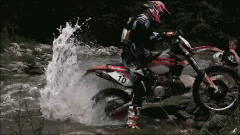a man on a dirt bike with the number 10 on the back