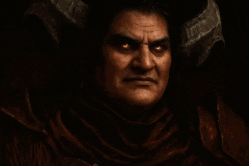 a man with horns on his head is smiling