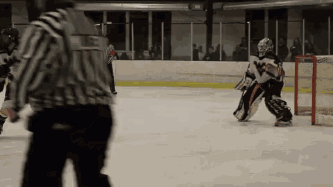 a hockey player wearing a jersey that says ' ice ' on the back