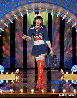 a woman in a sailor costume is walking down the runway