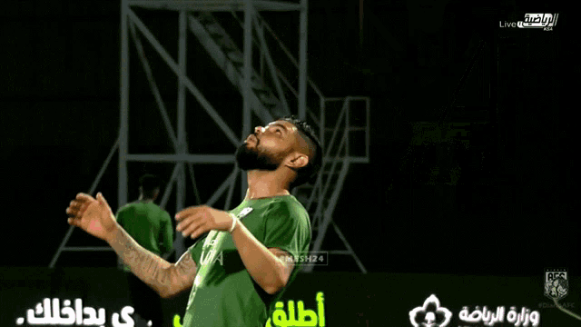 a soccer player in a green jersey with the word udia on the front