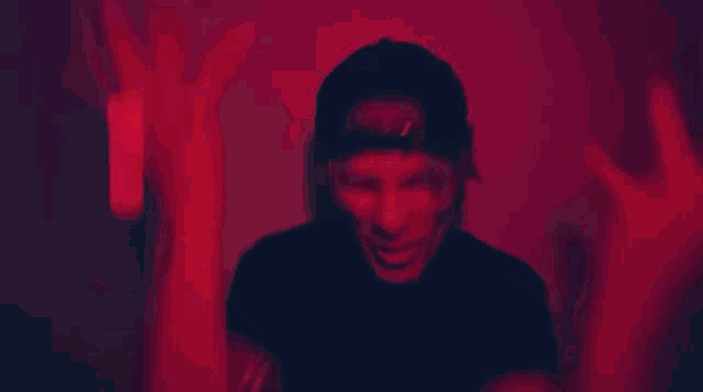 a person covering their face with a large red heart