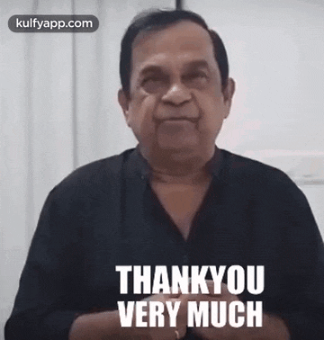a man in a black shirt is giving a thank you very much speech .