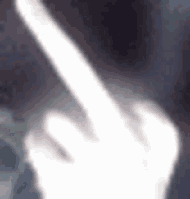 a blurred image of a person 's hand giving the middle finger .