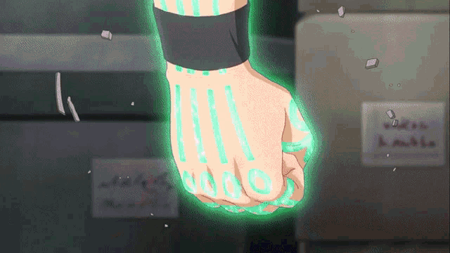 a person 's hand is glowing green and has a sticker on it that says ' ii '