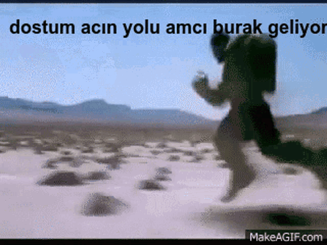 a gif of a man running in the desert with the words dostum acin yolu amci burak geliyor