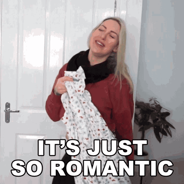 a woman with a scarf around her neck says it 's just so romantic while holding a blanket