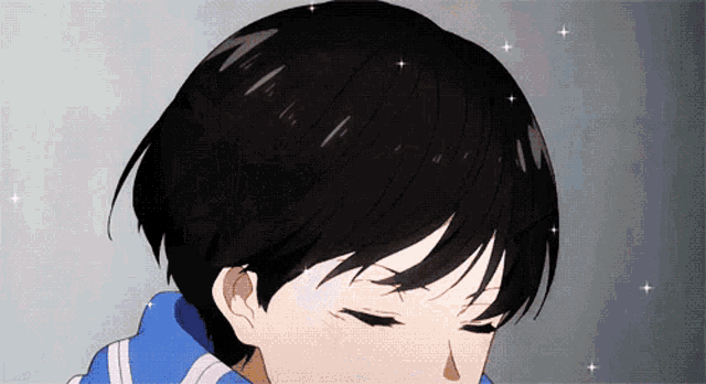 a close up of a person 's face with a blue jacket on