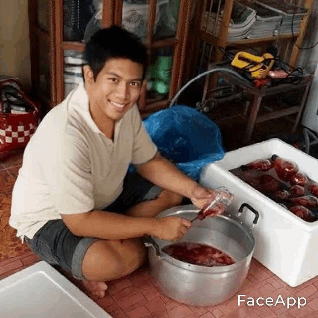 a man is kneeling on the floor next to a pot of blood .